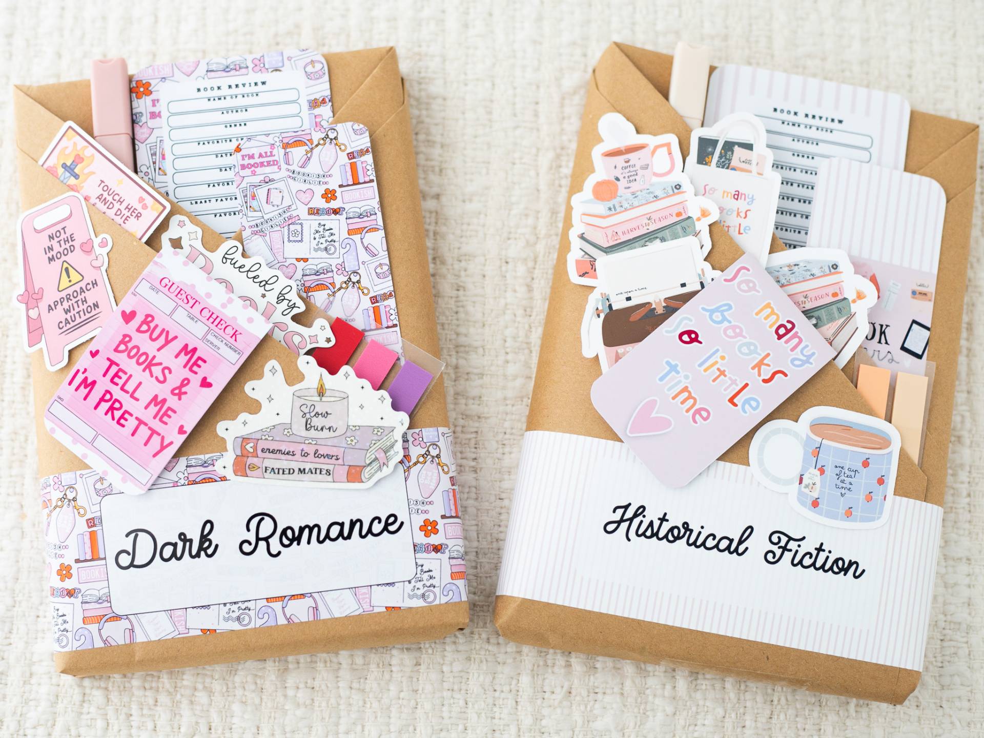 Dark Romance and Historical Fiction book packages with colorful bookmarks, stickers, and reading extras