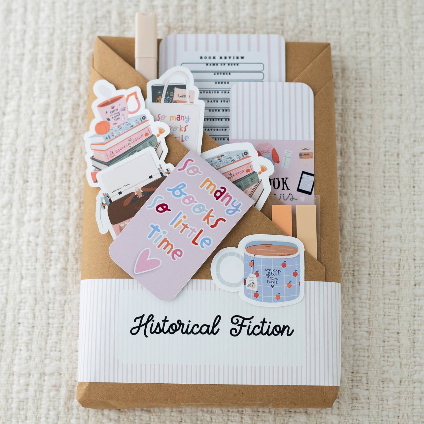 Historical Fiction Blind Date with a Book package with pastel reading cards, bookish stickers, and a tea cup illustration