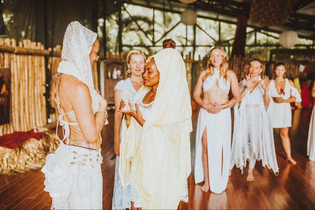 Sofiah Thom in a white hooded veil, lit by golden sunlight