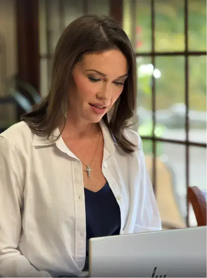 Laura DiBenedetto working at a laptop