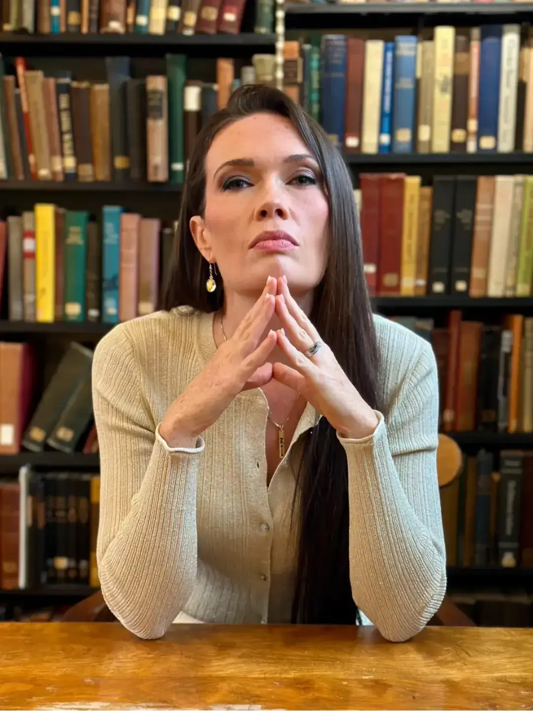 Laura DiBenedetto seated in a library