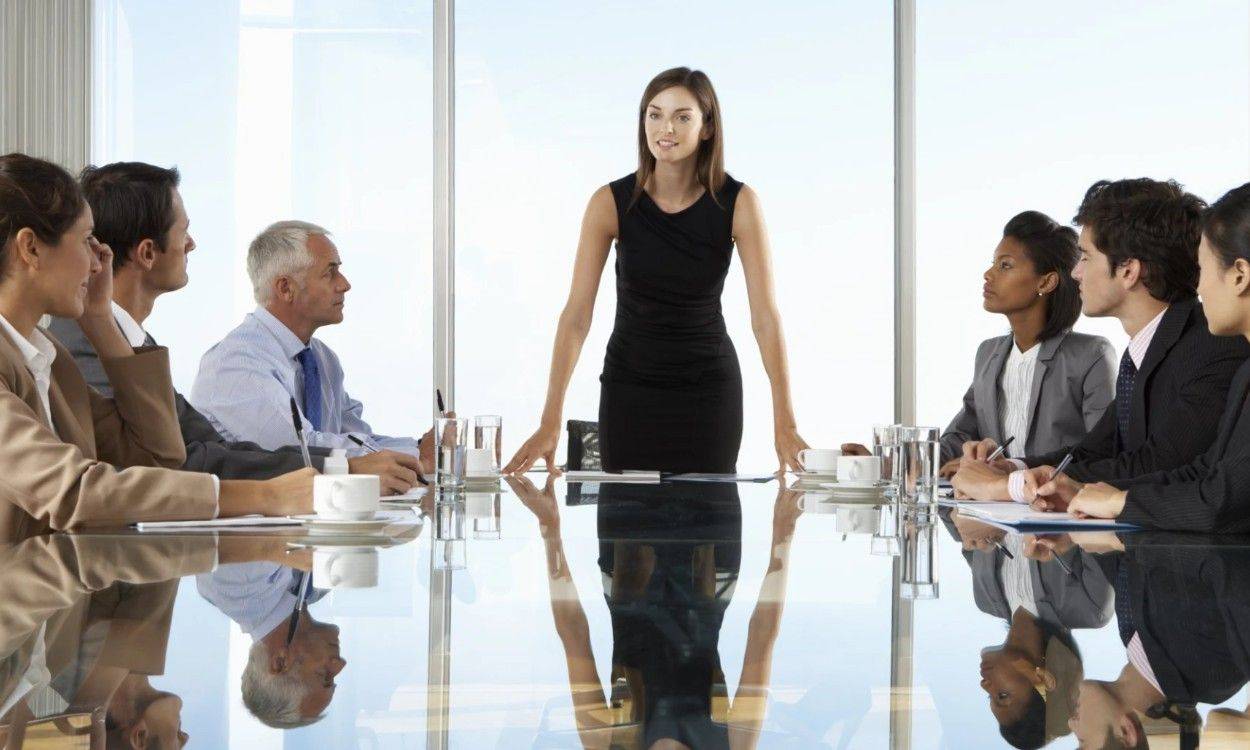 A confident executive presenting to her leadership team