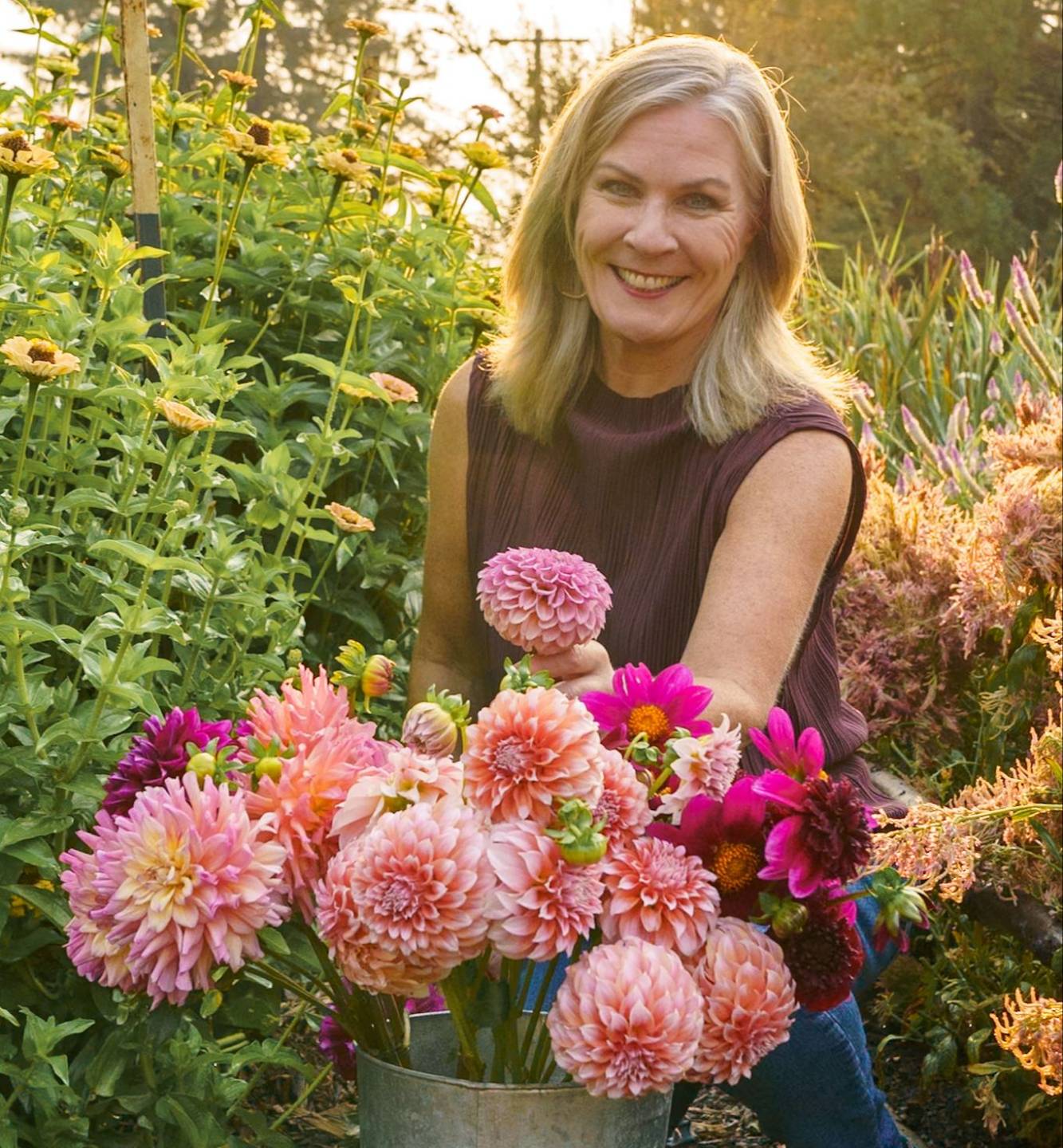 Charlotte Smith holding a basket of fresh-cut flowers from her farm
