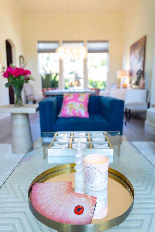 Oracle cards, a candle and a small crystal on a gold tray in Gina's living room