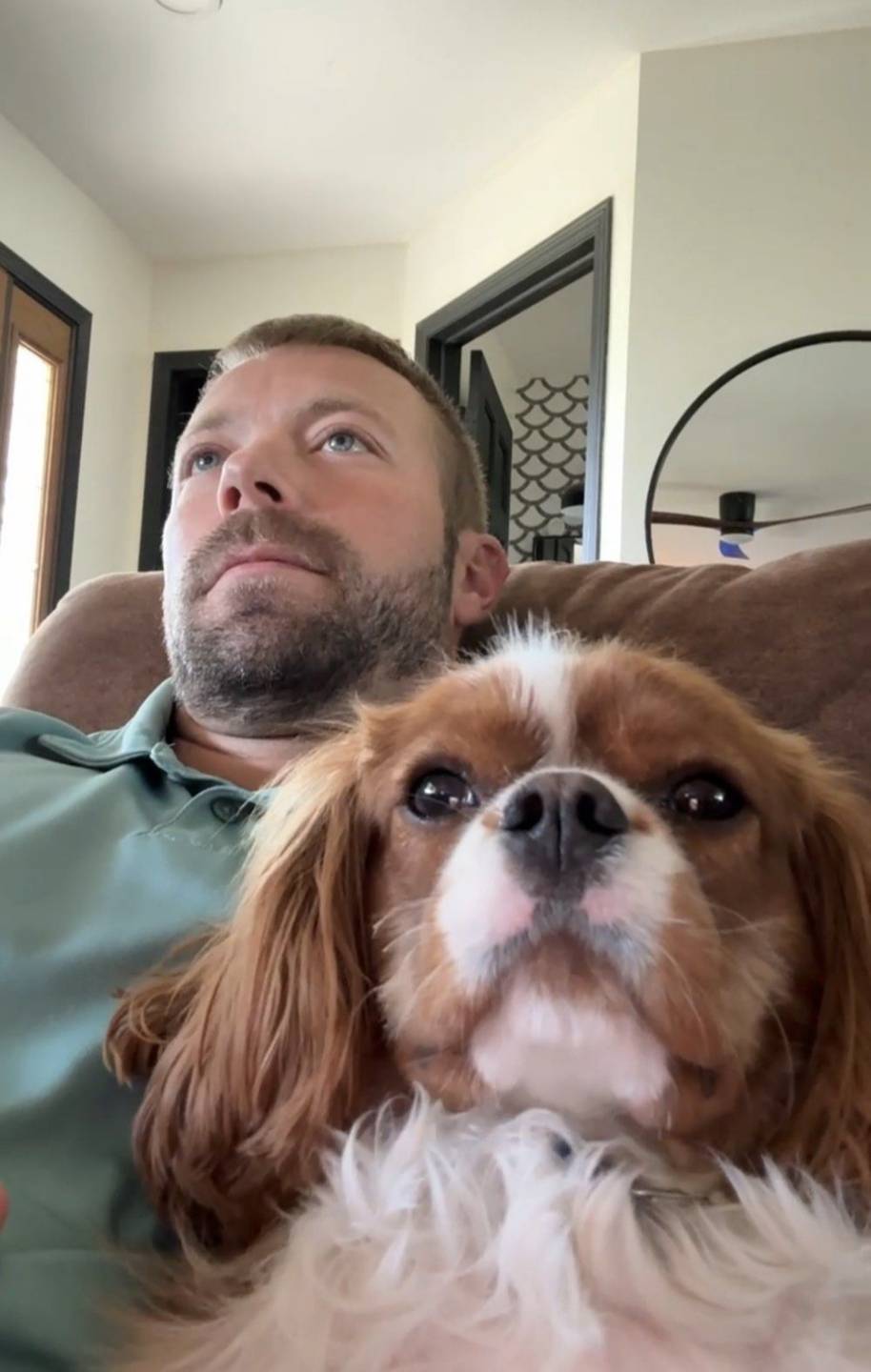 Lee on the couch with his Cavalier