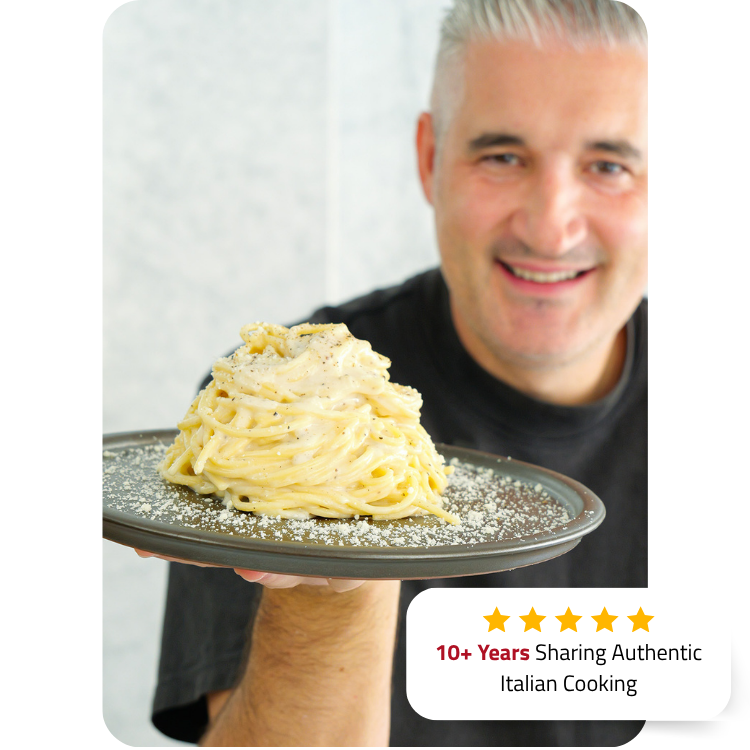 Vincenzo holding a plate of authentic Italian pasta