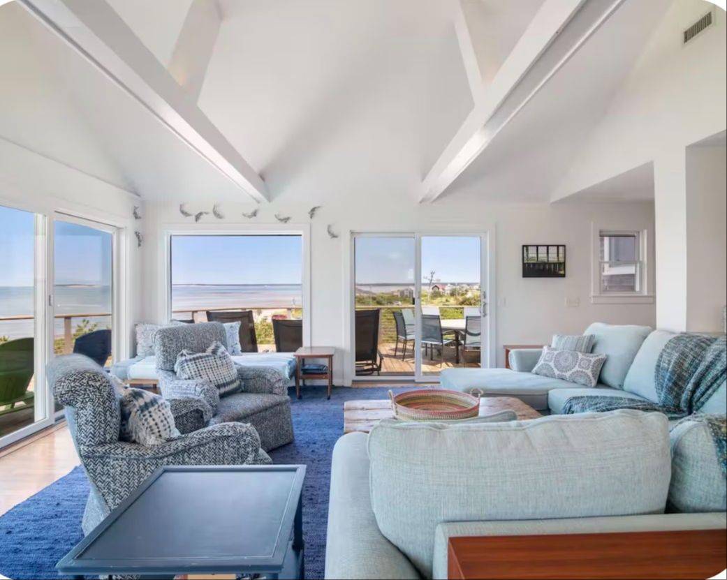 Light-filled living room overlooking the water at the Cape Cod retreat home