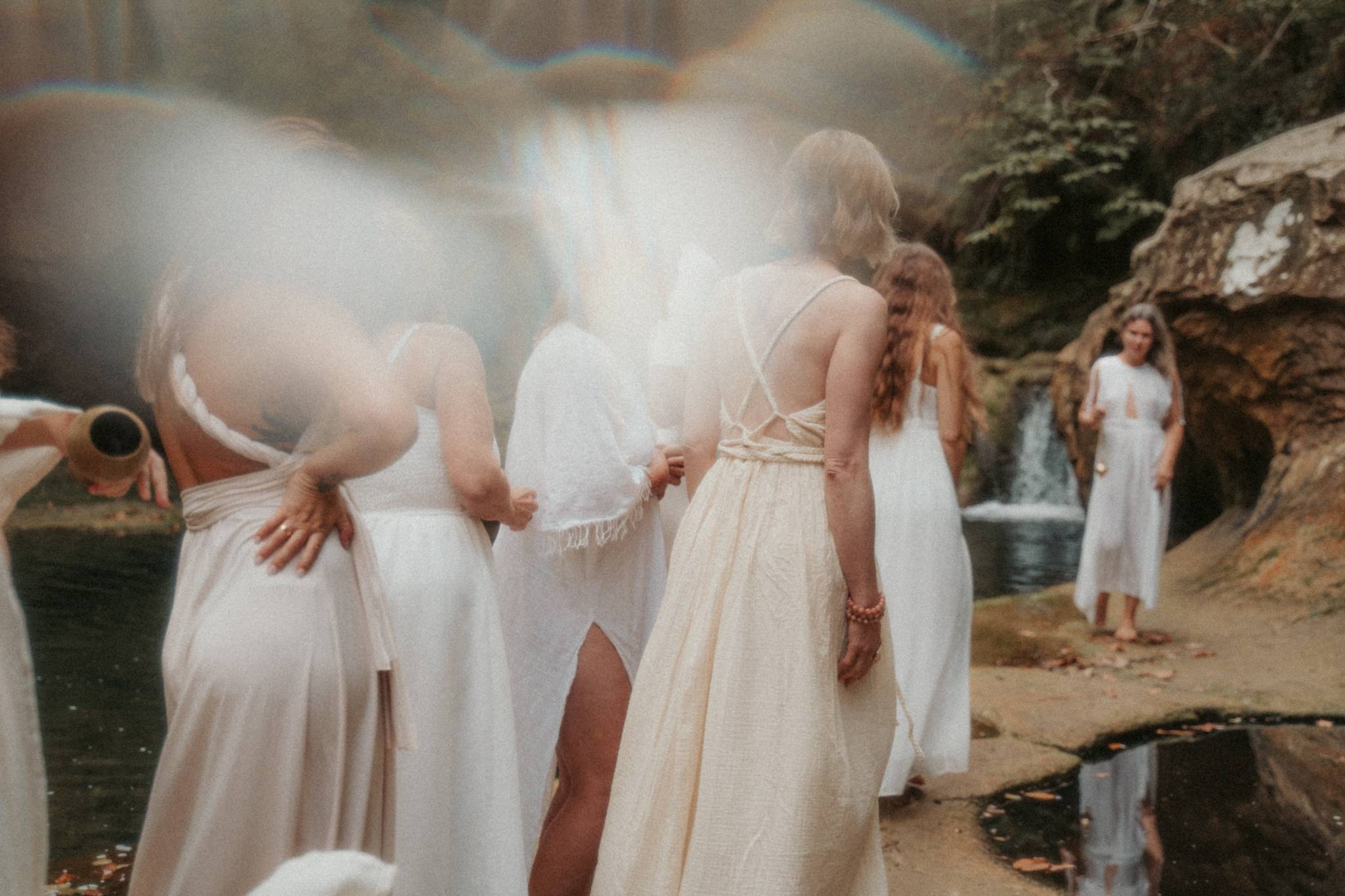 Women gathered beside the waterfall during Natalia’s retreat in Southern France