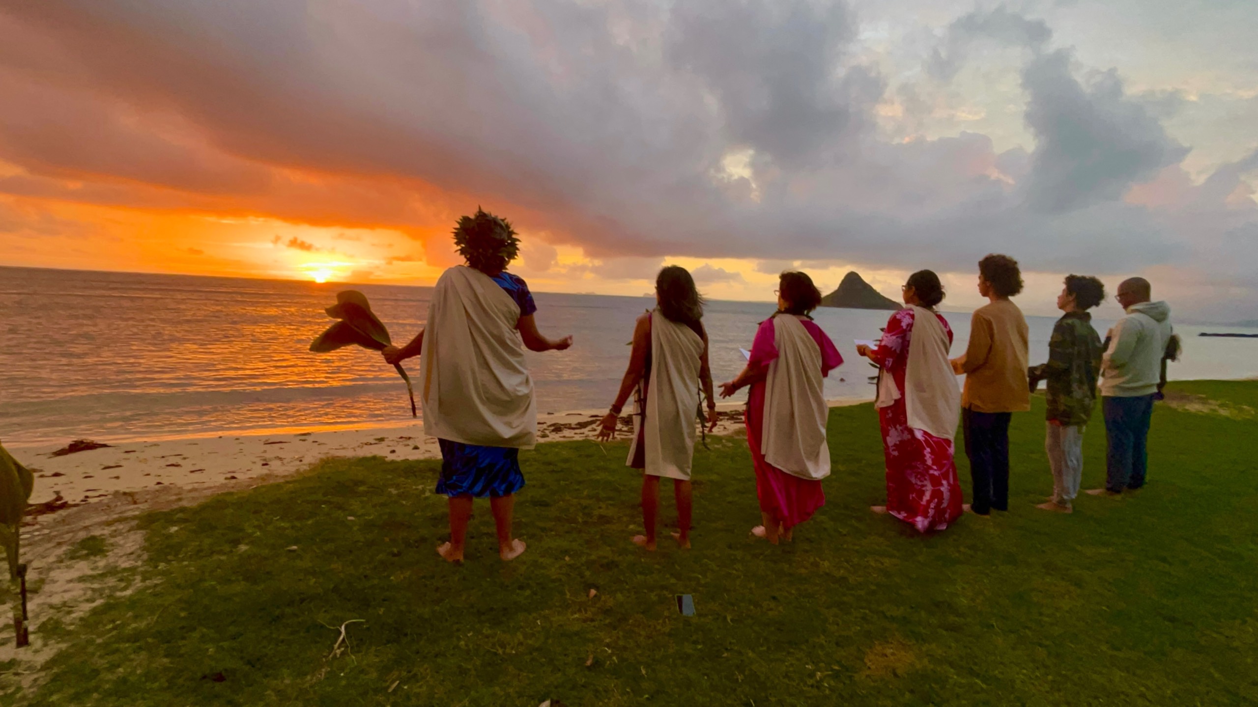 Kahu Lāhela and a group reciting a Hawaiian chant, greeting the rising sun in the east on Spring Equinox.