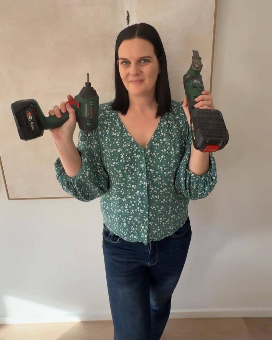 Jade holding a drill and a multi-tool