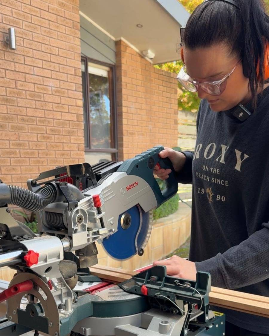 Jade lining up a cut on a mitre saw