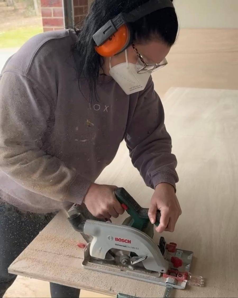 Jade ripping a full sheet of timber with a circular saw