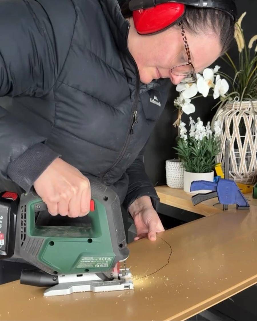 Jade cutting a curve with a jigsaw