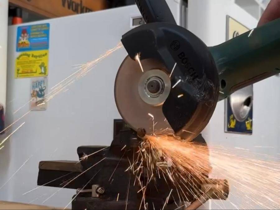 Sparks flying as an angle grinder cuts through metal