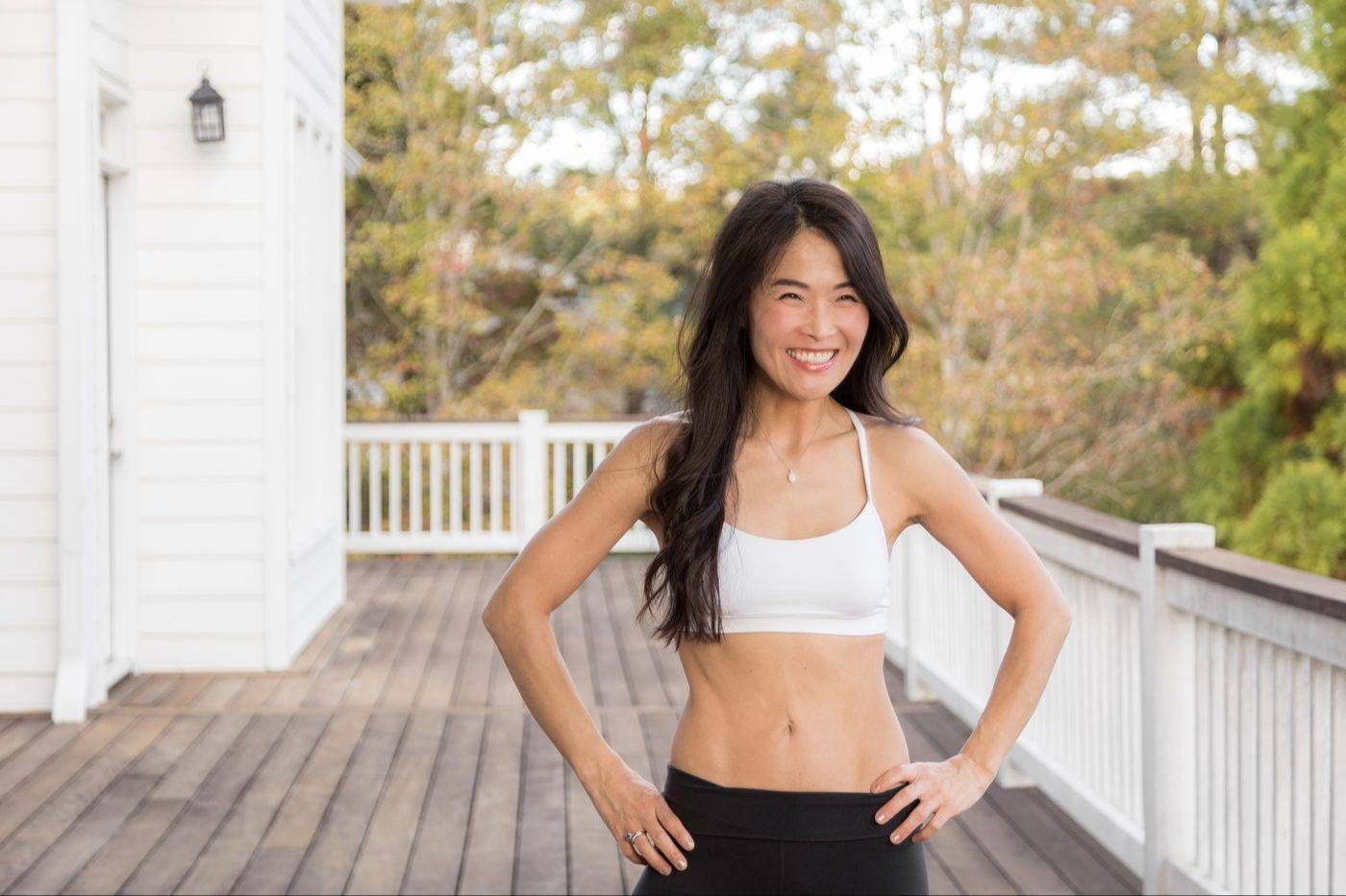 Dr. Connie Cheung smiling with hands on hips on her deck