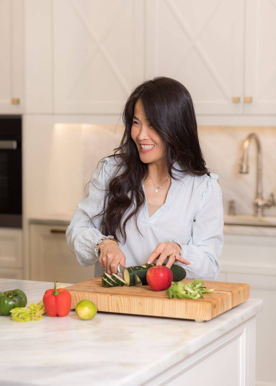 Dr. Connie Cheung preparing fresh vegetables in her kitchen