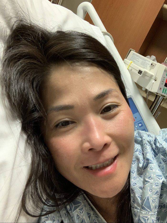 Dr. Connie Cheung smiling in a hospital bed