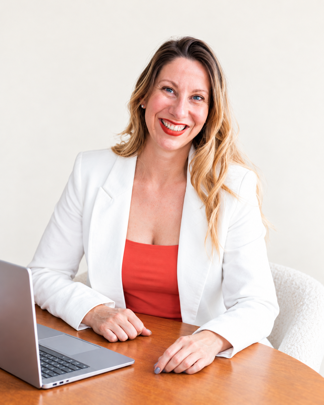 Charlotte Fuller, founder of The Achievement Algorithm, seated at a desk