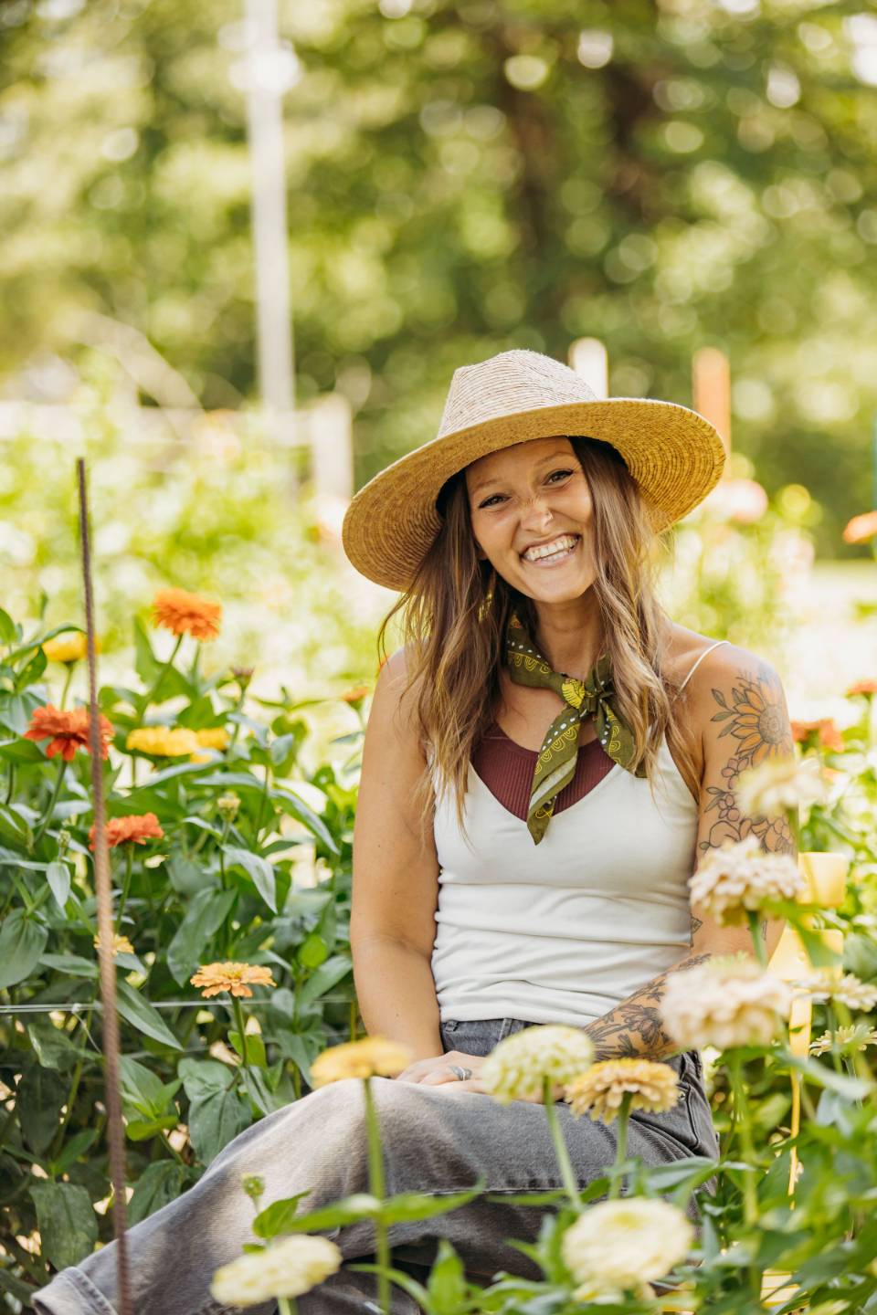 Jill in overalls holding seedlings in the greenhouse