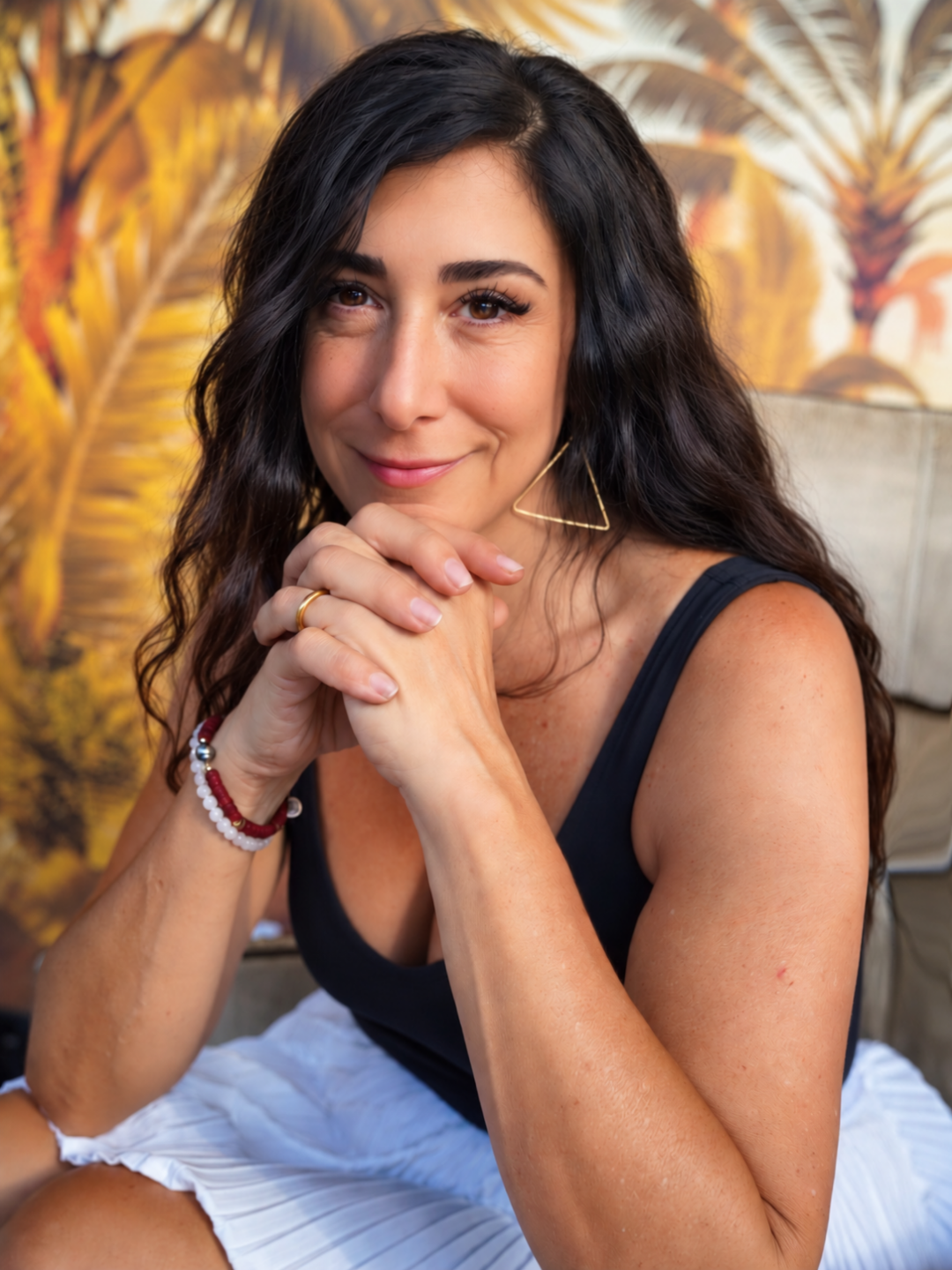 Dina listening with her hands beneath her chin.