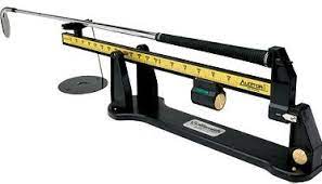A swingweight scale measures the balance of the assembled club.