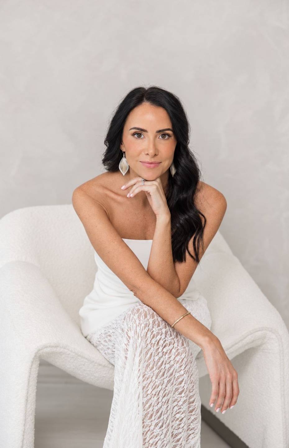 Juliette Kristine, creator of the Vision Board Template Pack, seated in a white chair.