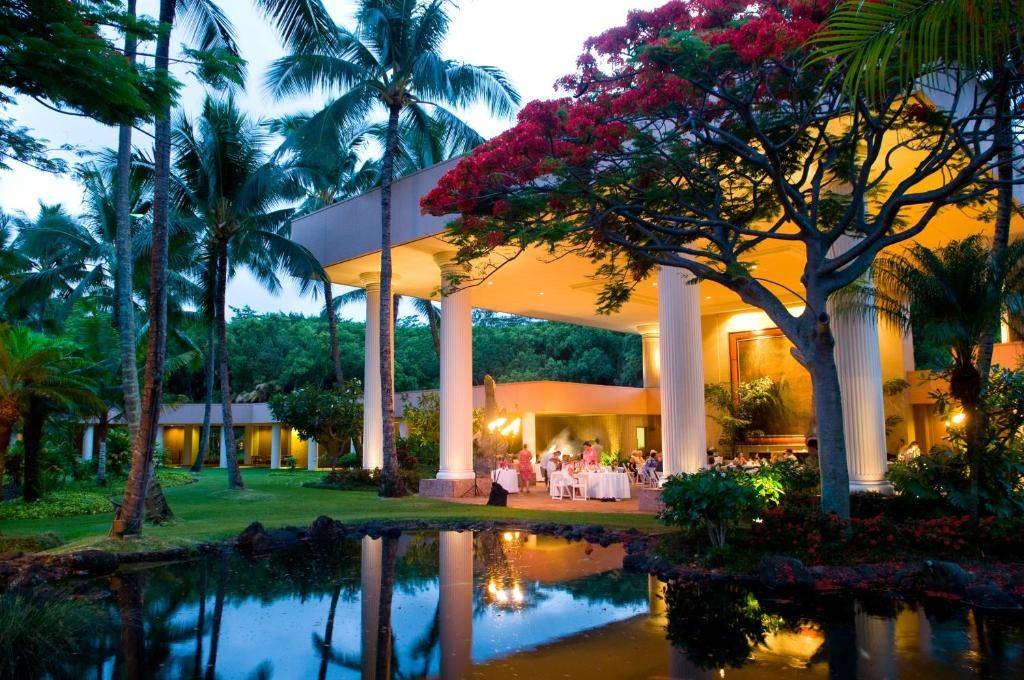 Tropical gardens, palms and illuminated pavilion at the Royal Sonesta Kauaʻi Resort