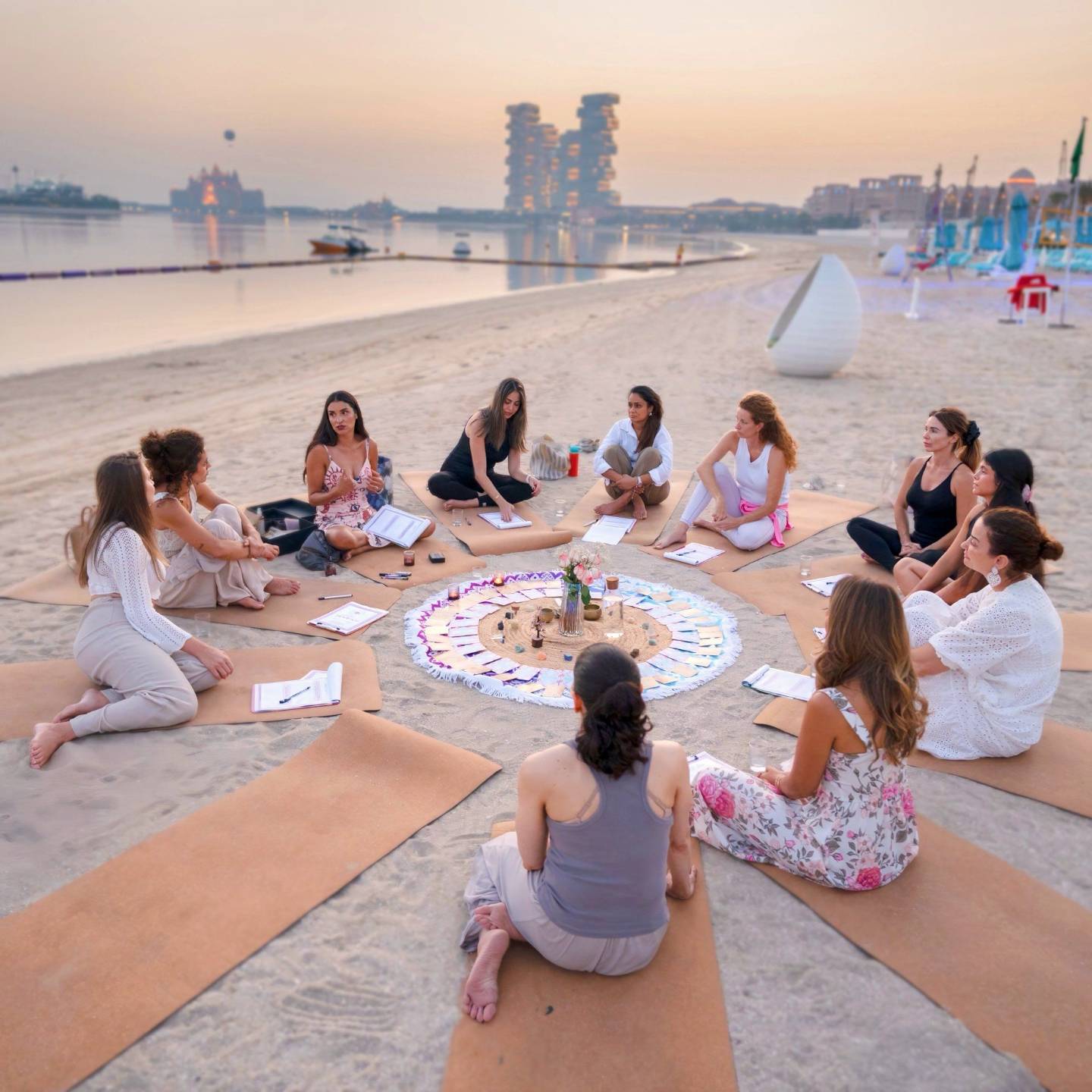 A full moon circle gathering on the beach