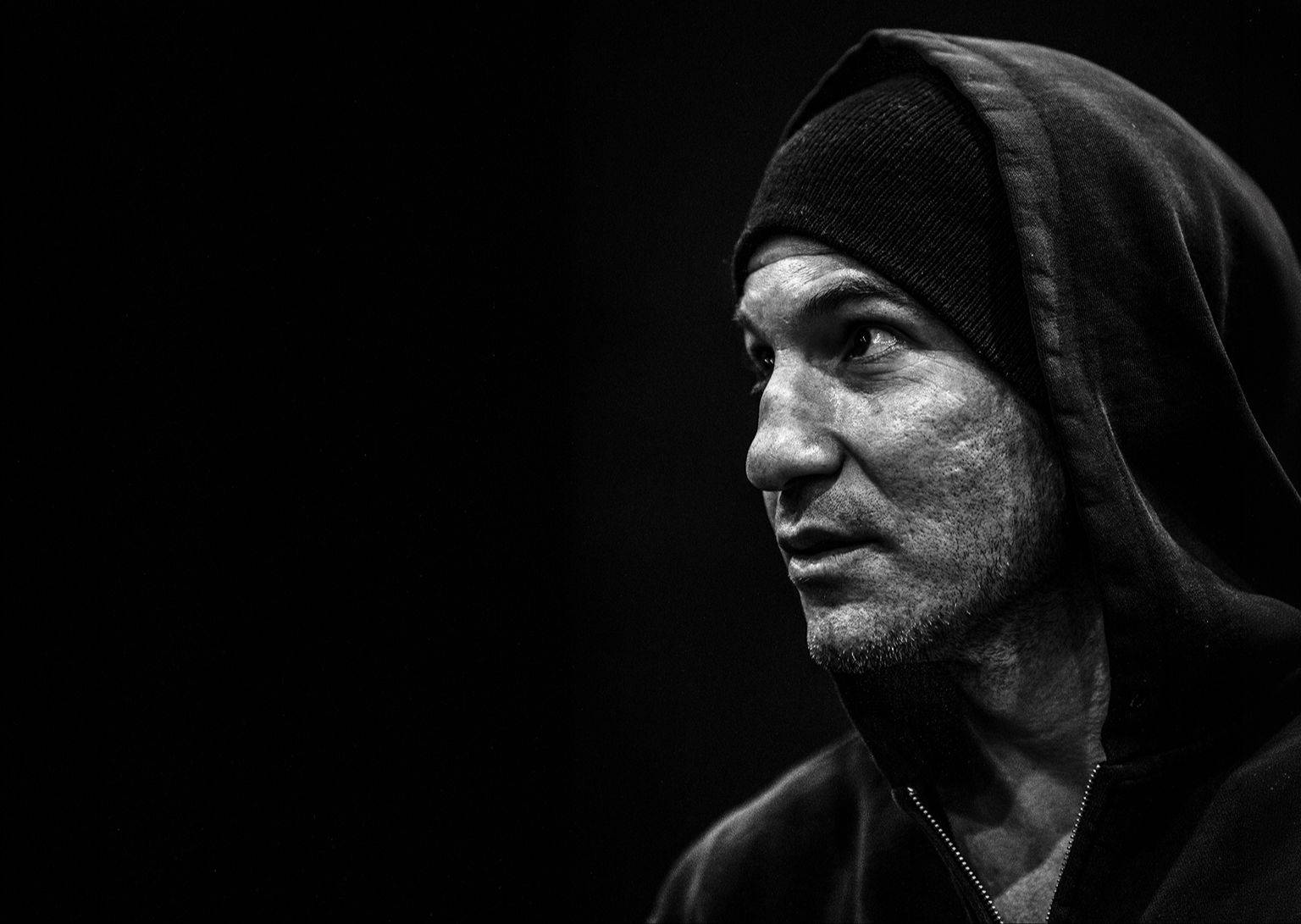 Jon Bernthal dramatic side-lit portrait in a hood, portrait photography by Mark Kaye
