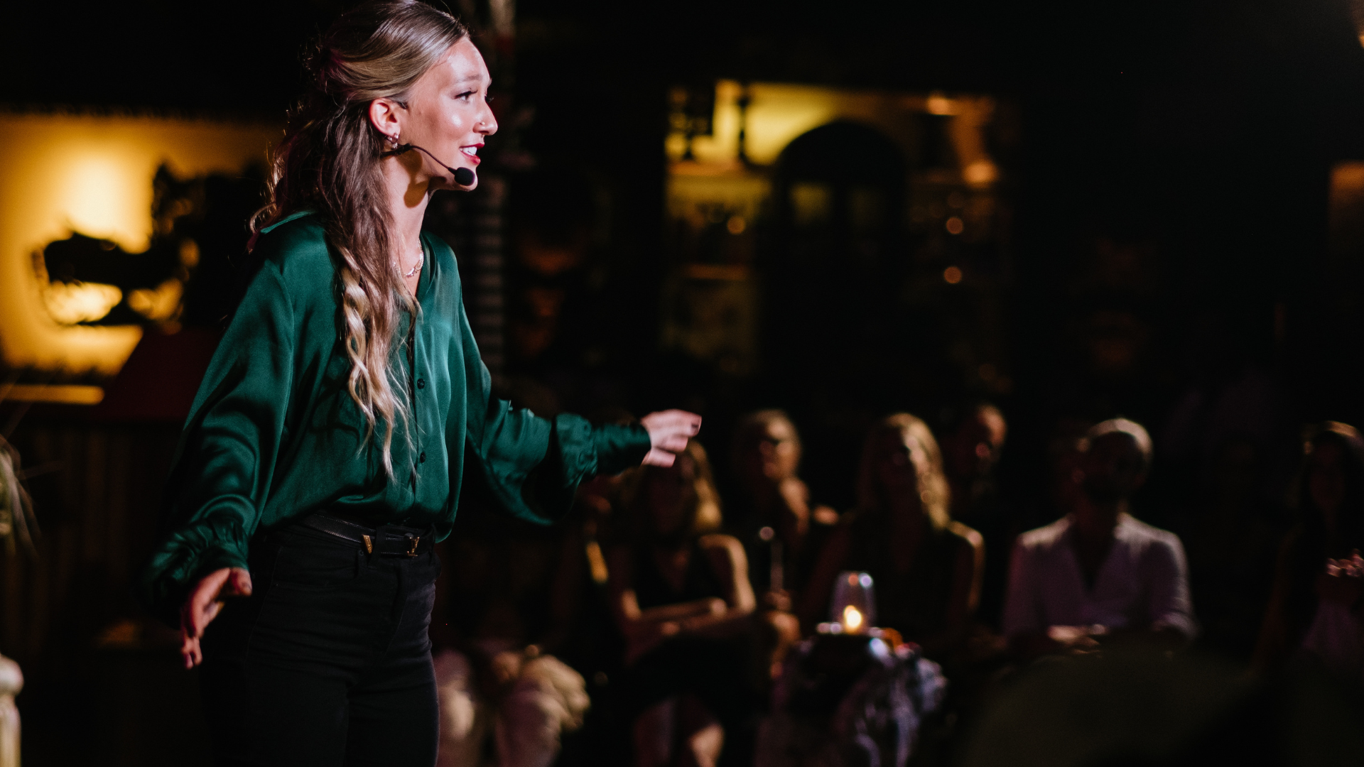 A speaker sharing her story with a live audience