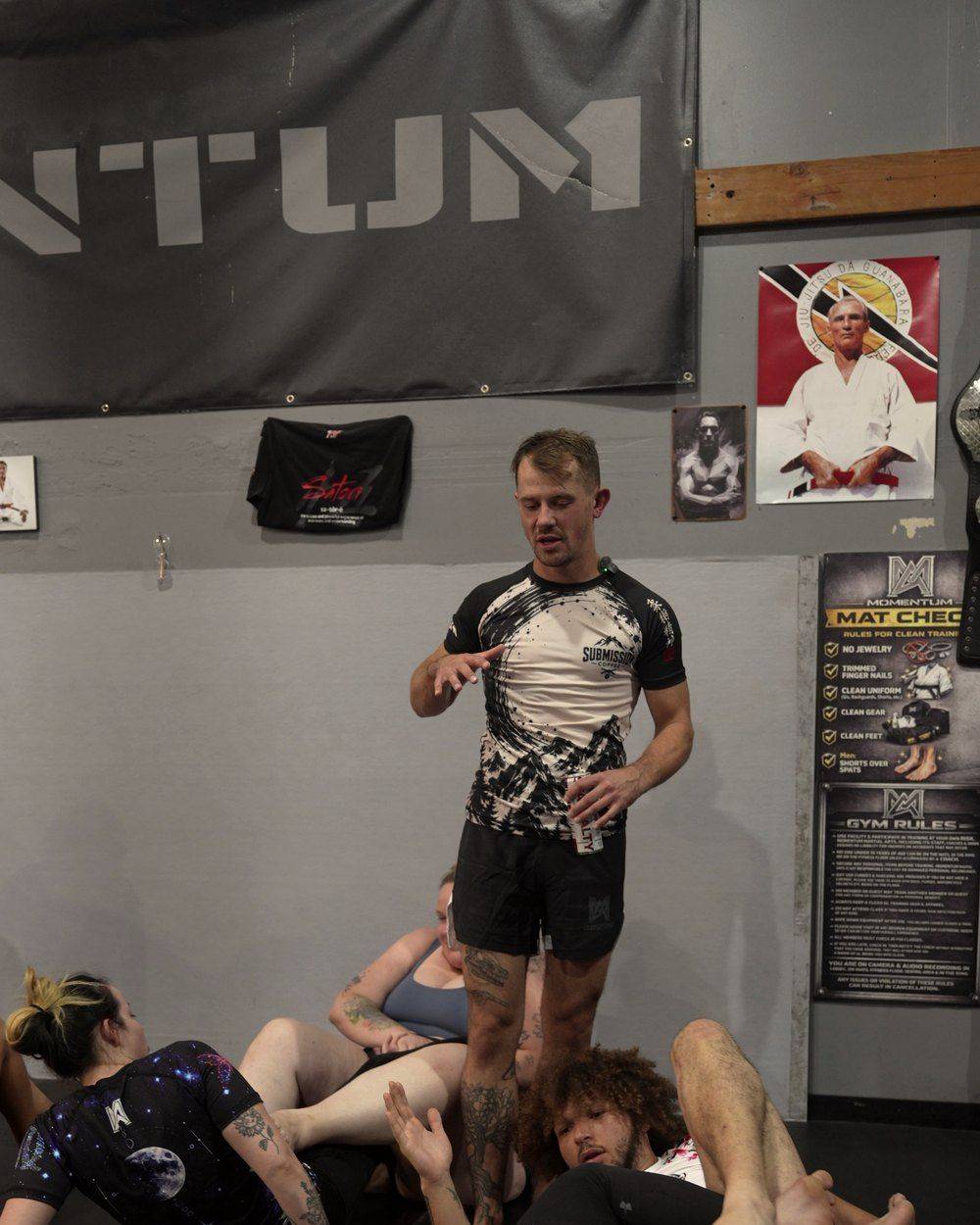 Professor Darien Cobon coaching students on the mat at Momentum Martial Arts