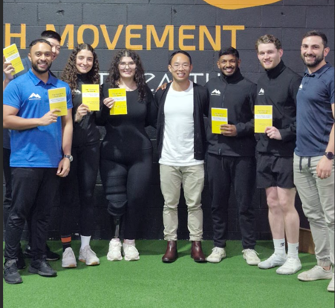 Clinicians holding their copies of The Clinician's Handbook