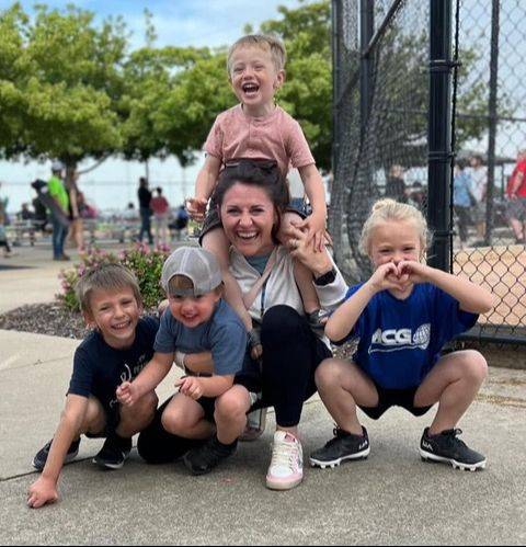 Chelsey laughing with her kids at the ballfield