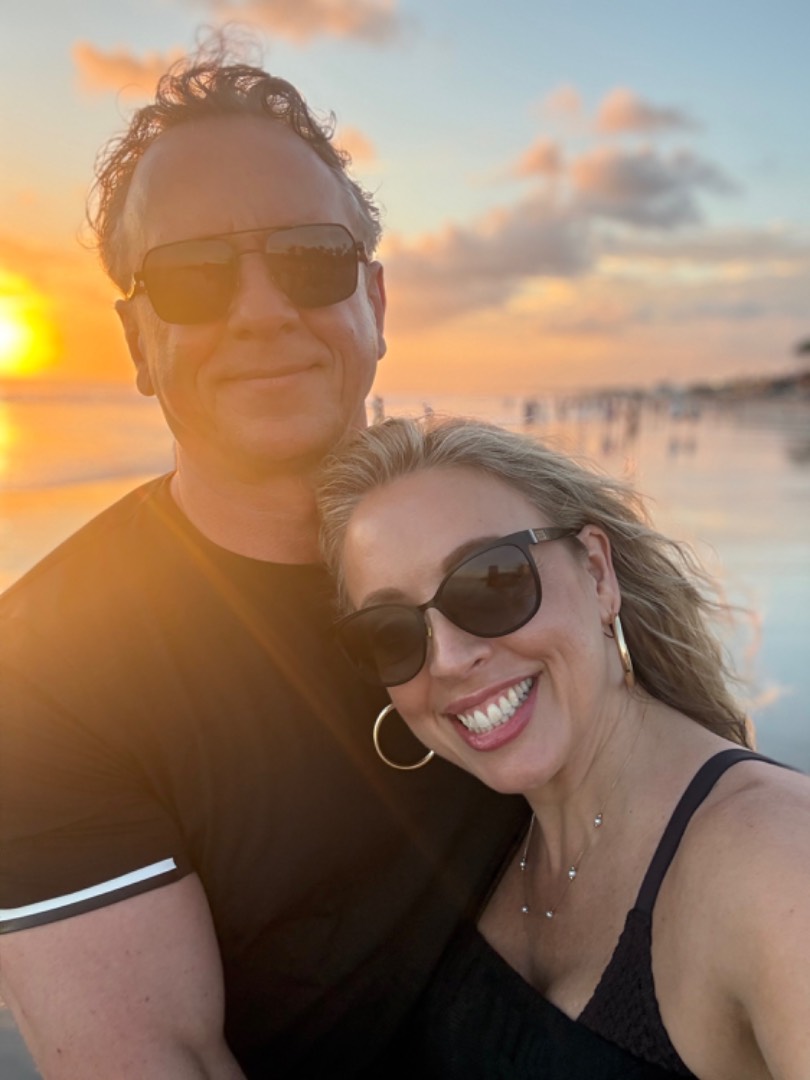 Shari and her husband at sunset on a beach in Bali