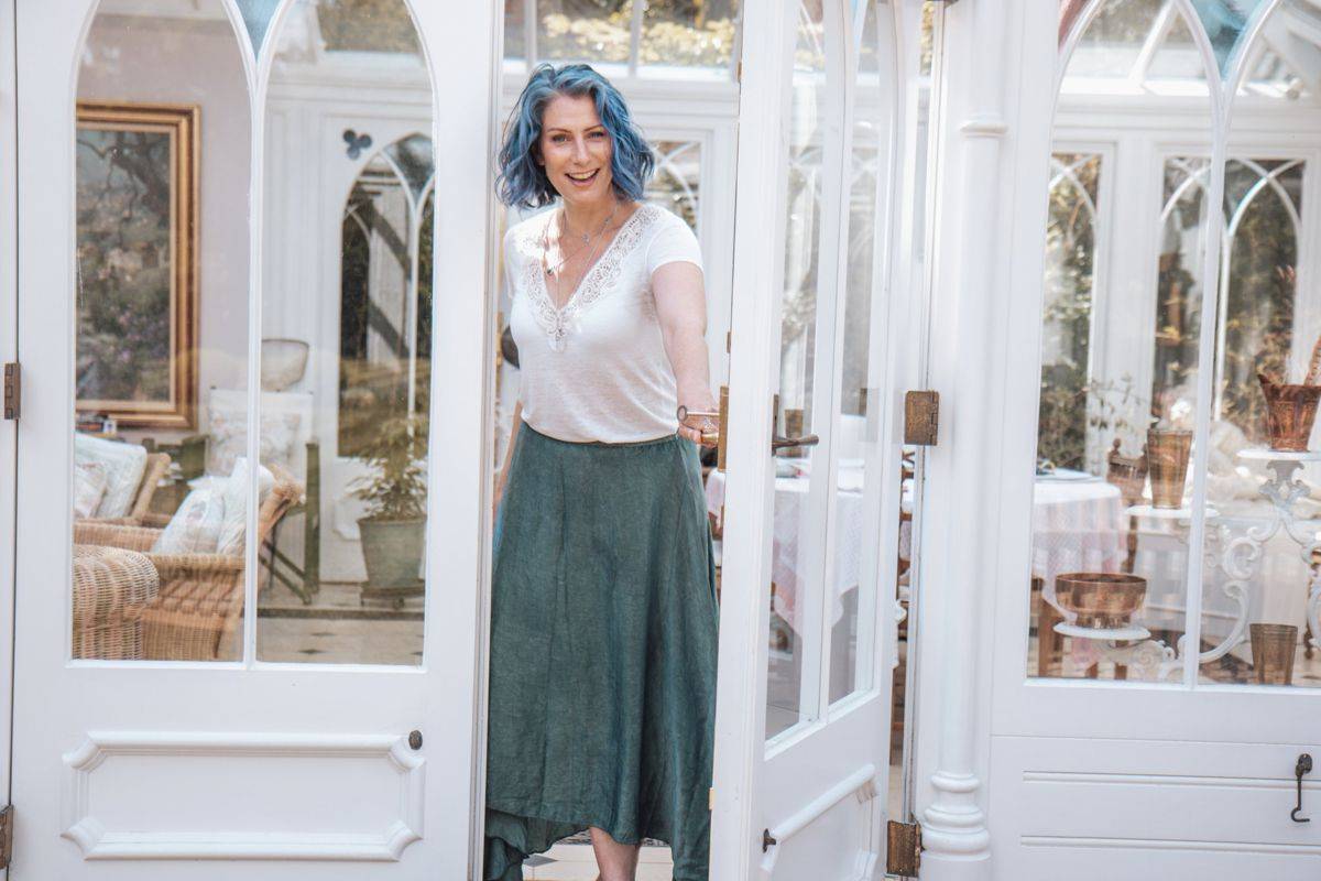 Katie Crooks opening a door, smiling