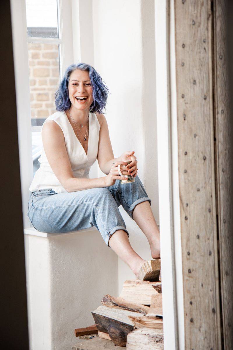 Katie Crooks laughing in a window seat