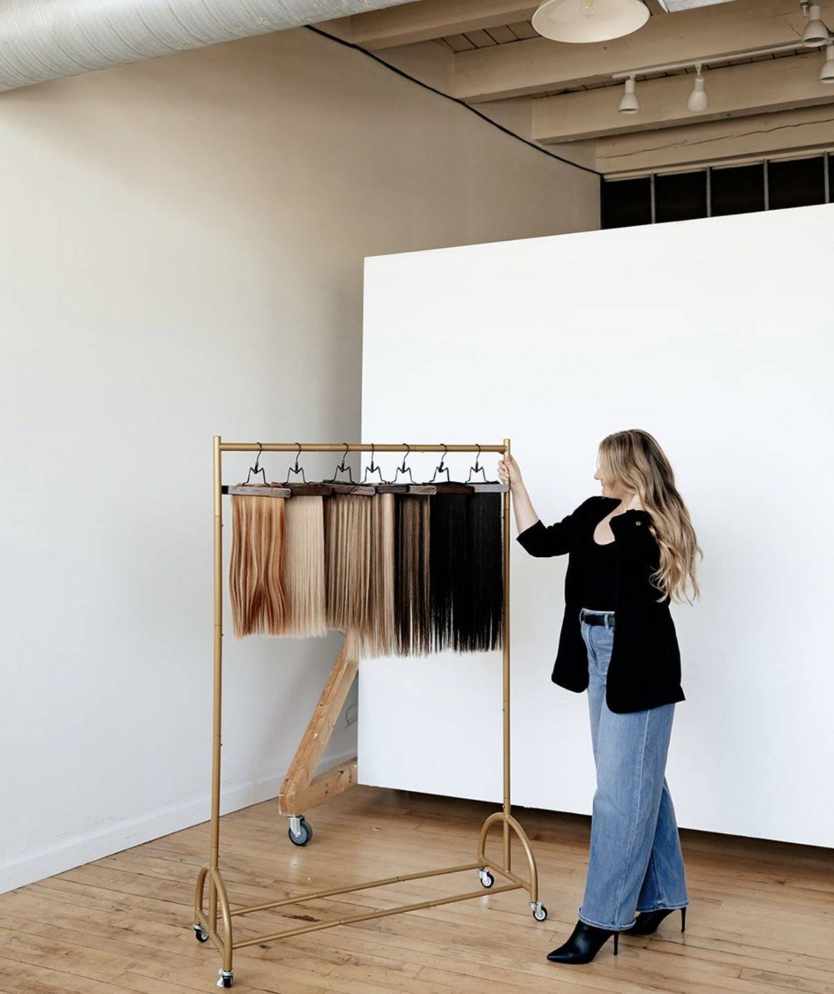 Kristen Wirth beside a gold rack of Alter Ego extensions