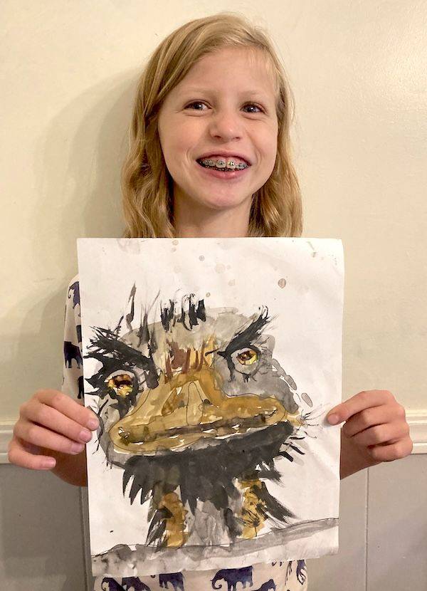 Grace, age 9, holding her Artventure artwork of an Emu bird