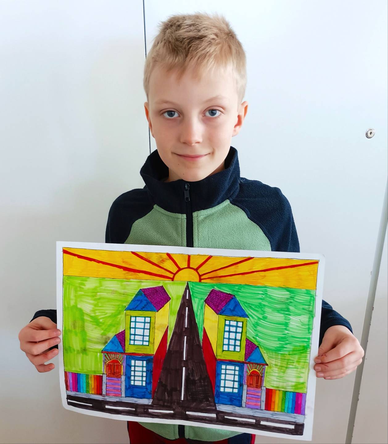 Benjaminas, age 9, holding his Artventure artwork of a vanishing point landscape
