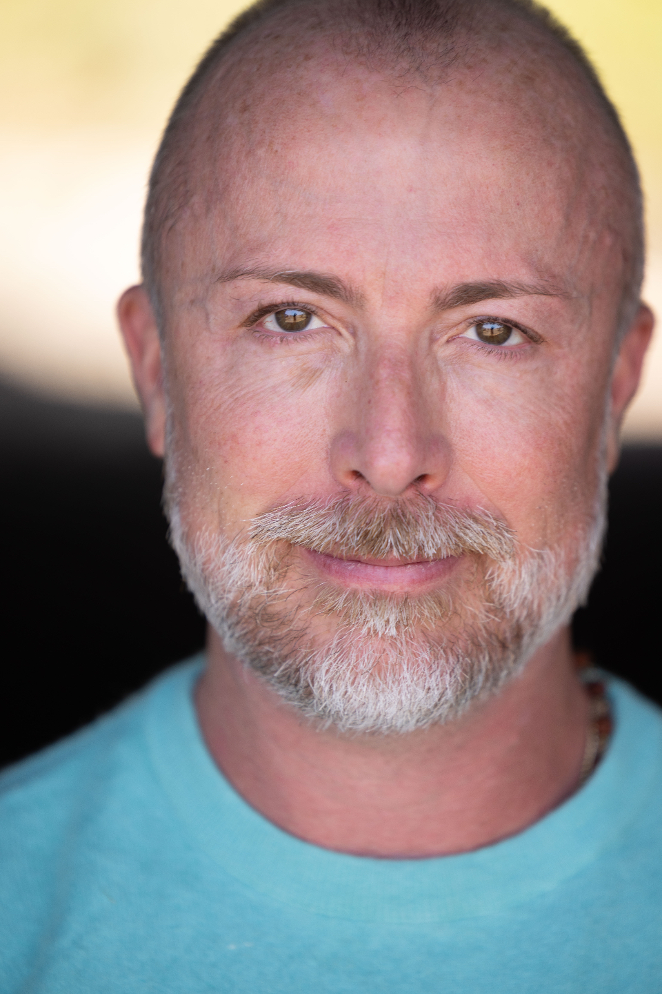 Closeup of man in teal sweater