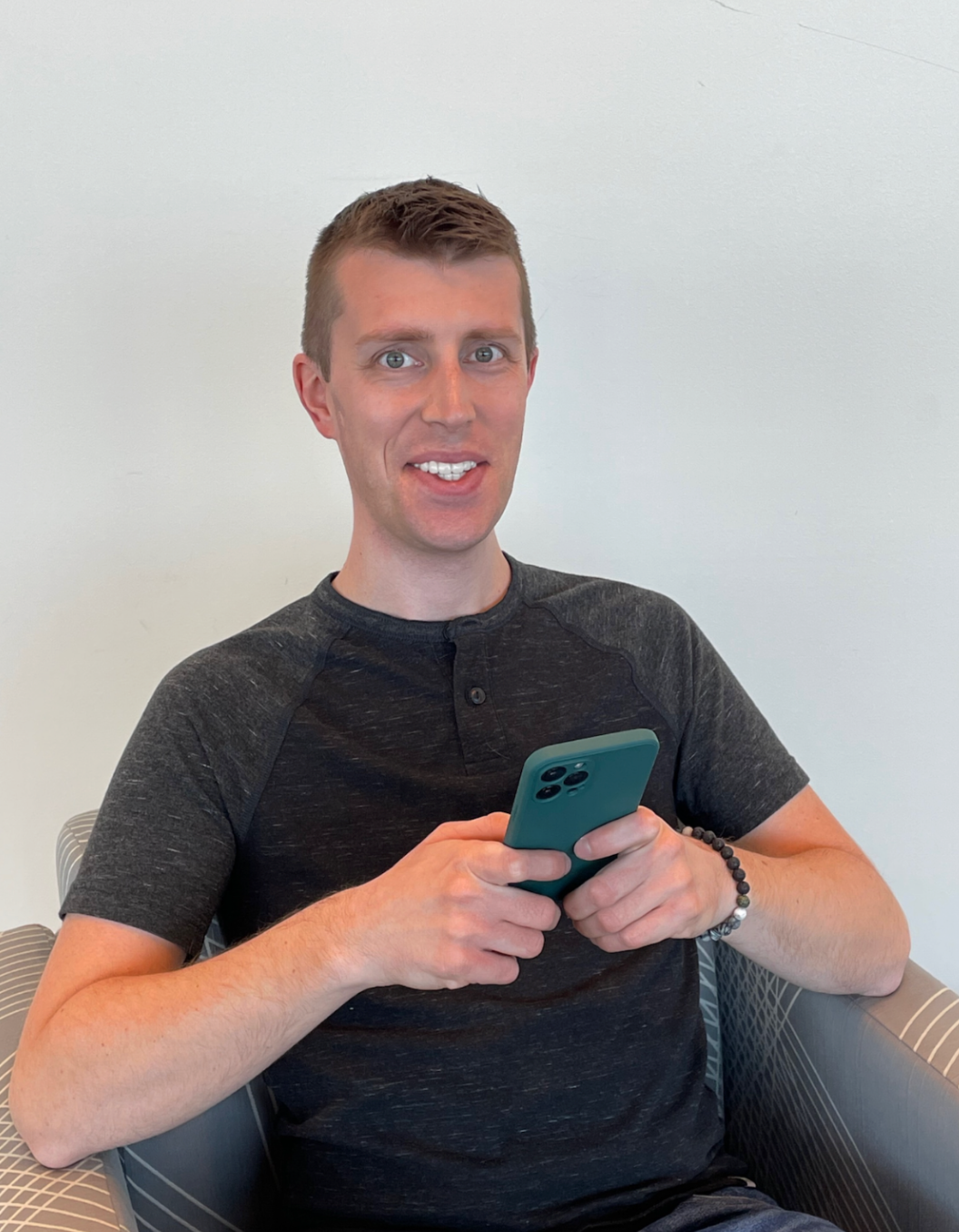 zac leaning against wooden bridge wall