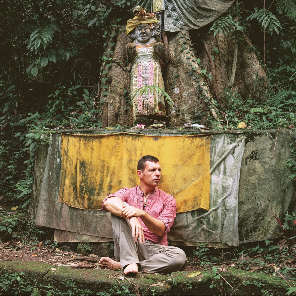 Dr Miles Neale standing outdoors in a mountain landscape