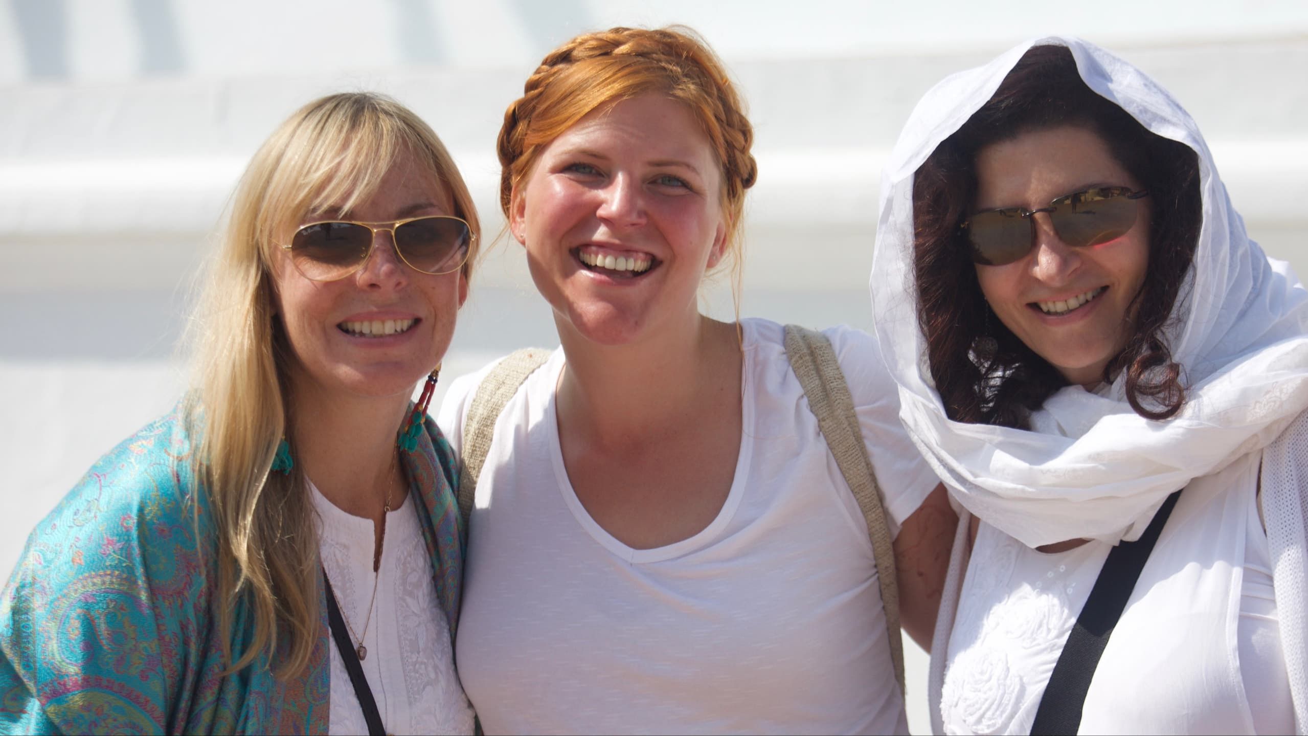 Pilgrims, including Kathryn Fink, smiling together at a sacred site during the journey.