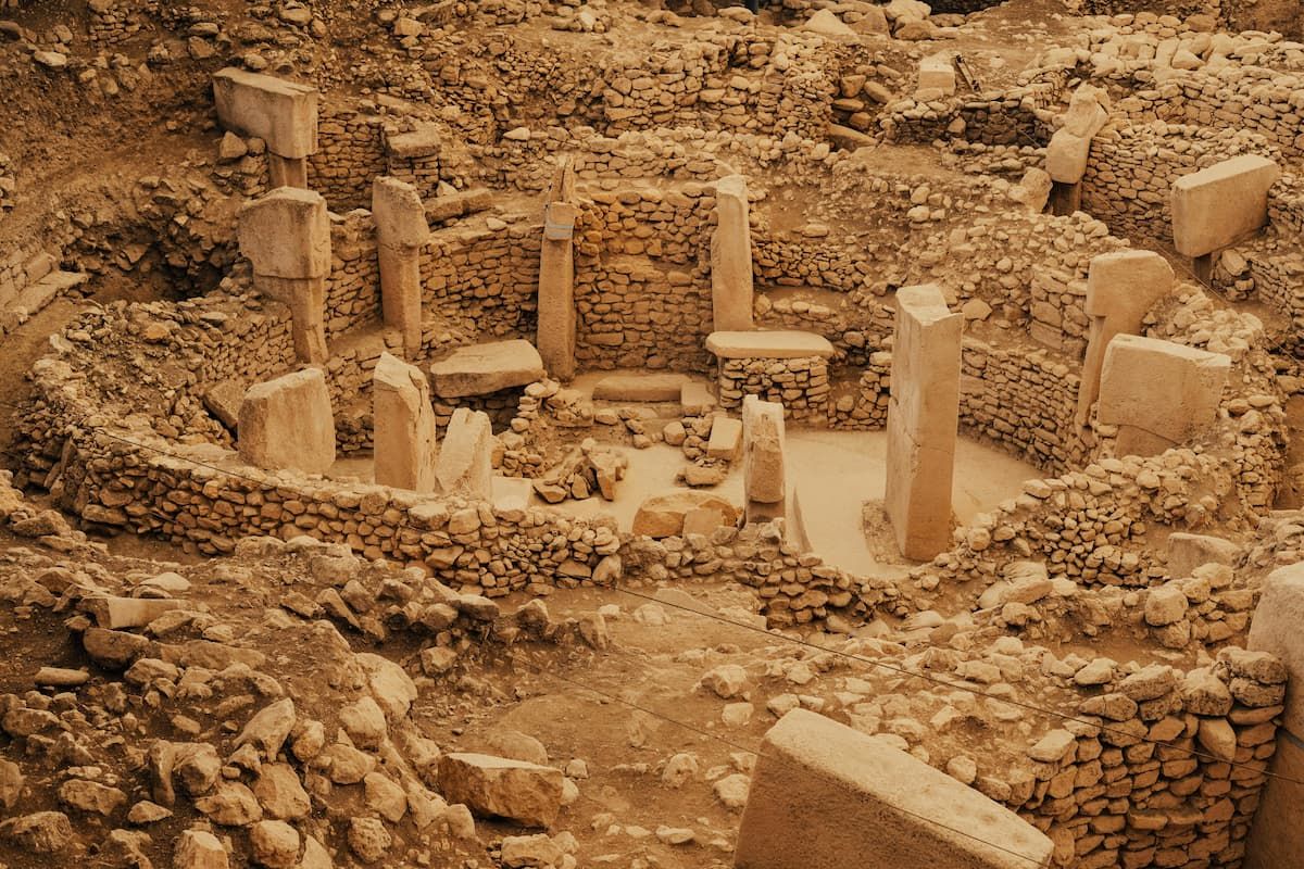 Ancient stone pillars and circular enclosures at Göbekli Tepe archaeological site in Turkey.