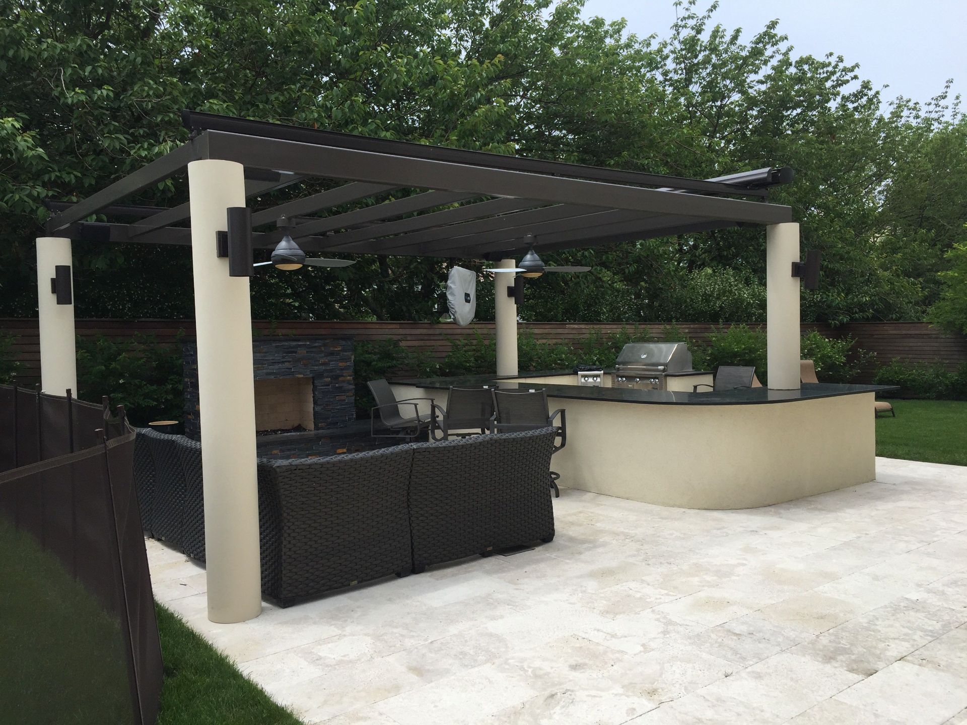 Contemporary Outdoor Kitchen with black upper elements and white circular non-tapered columns.