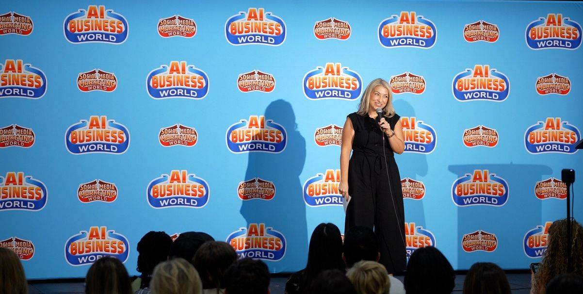 Cassandra Thompson speaking onstage to a professional audience