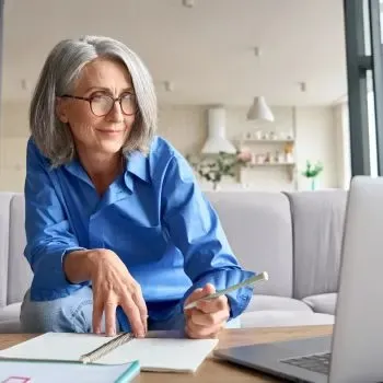 Black woman smiling looking at her laptop