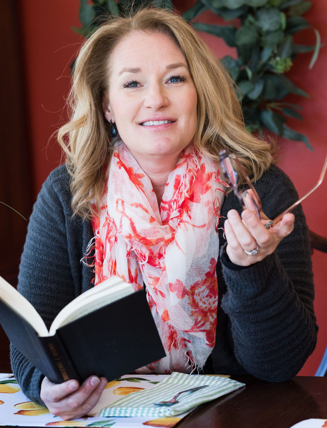 Jen Liddy, Brand Voice & Messaging Strategist, sitting on a couch with a coffee mug