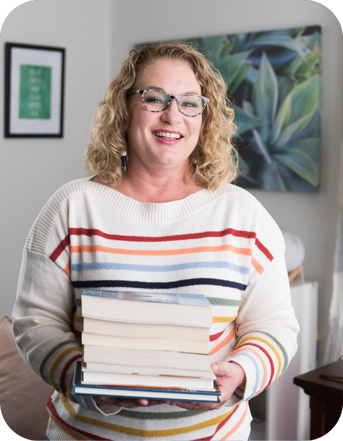 Jen Liddy, Brand Voice & Messaging Strategist, with a book in her hand
