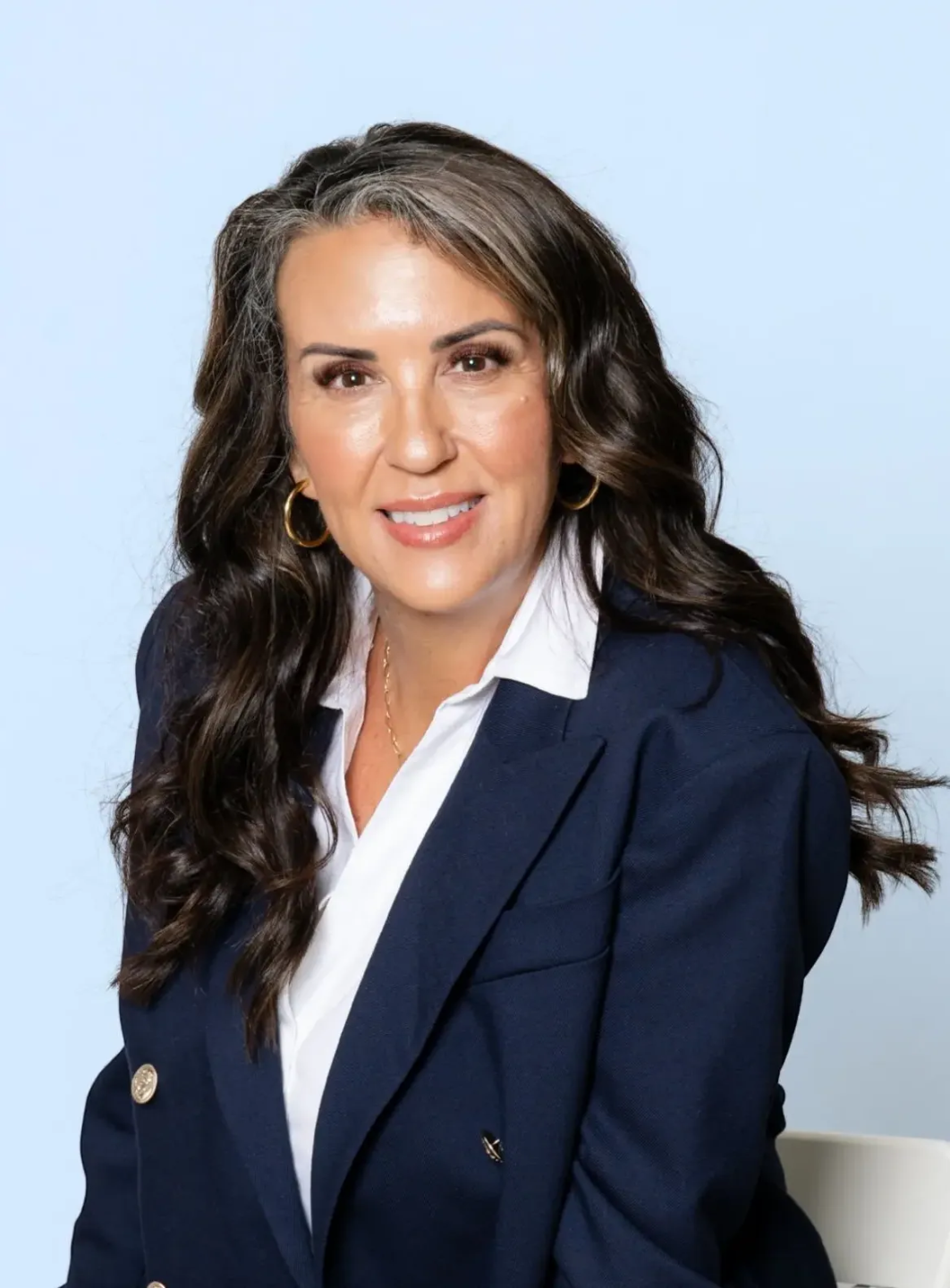 Dr. Lisa Muehlenbein, PhD, NBC-HWC, smiling confidently in a navy blazer — founder of the MedLife Matrix and advocate for physician families.